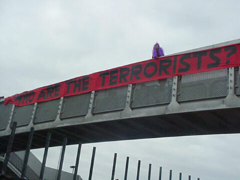 Banner dropped from overbridge: 'who are the terrorists?'